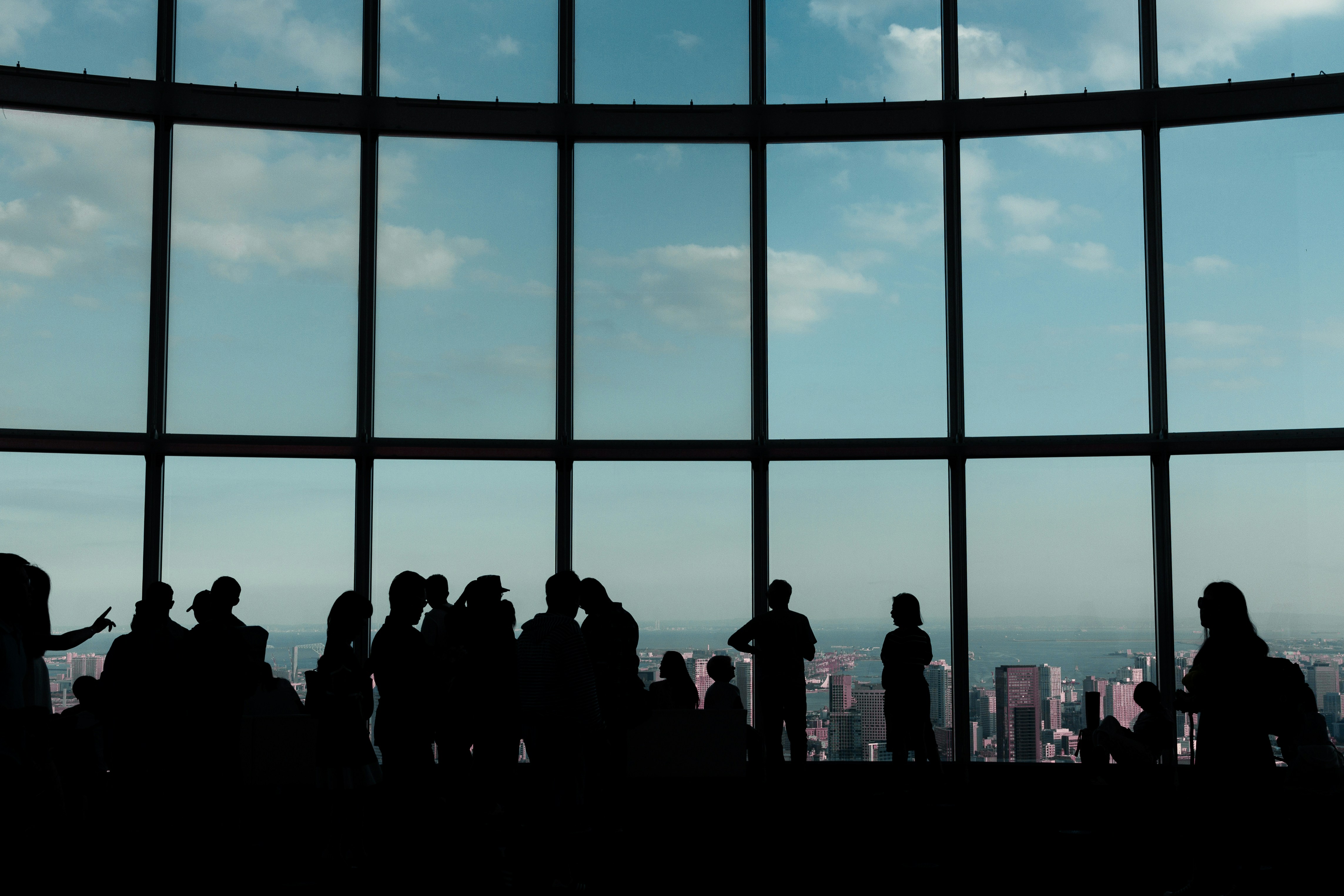 A group of people standing in front of a window photo – Free Japan ...