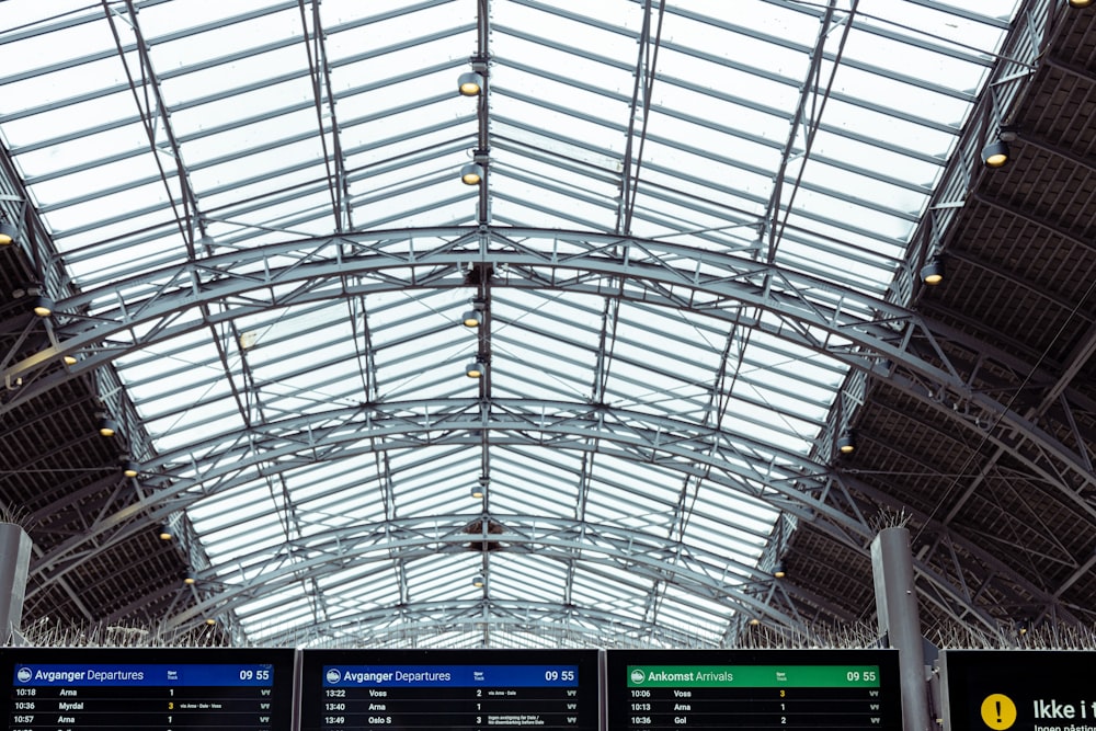 the ceiling of a train station with a clock on it