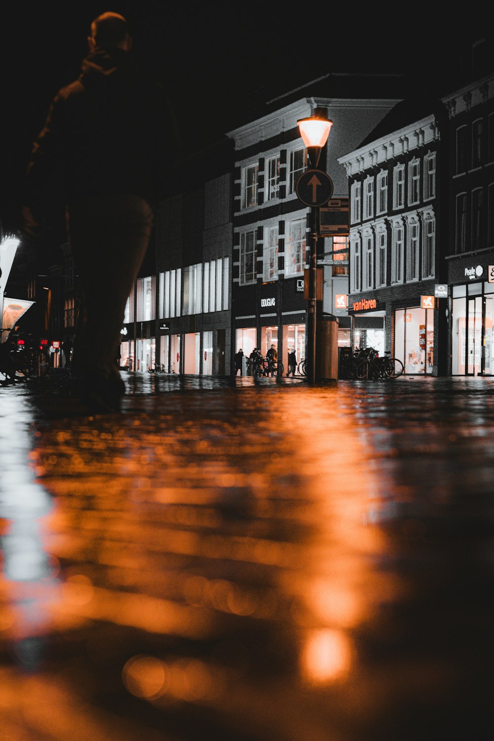 a person walking down a street at night