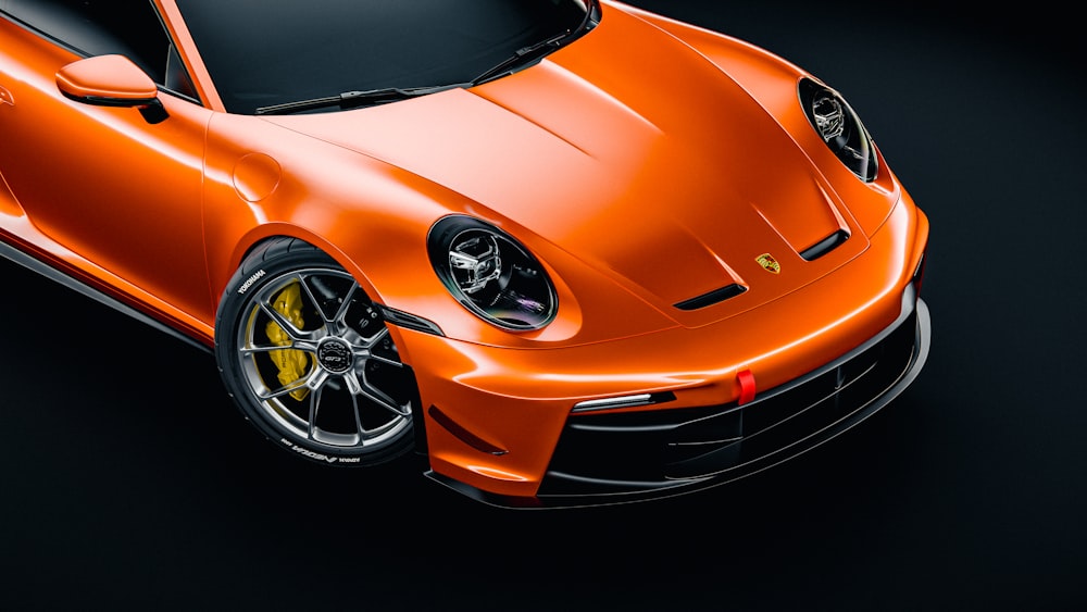 an orange sports car on a black background