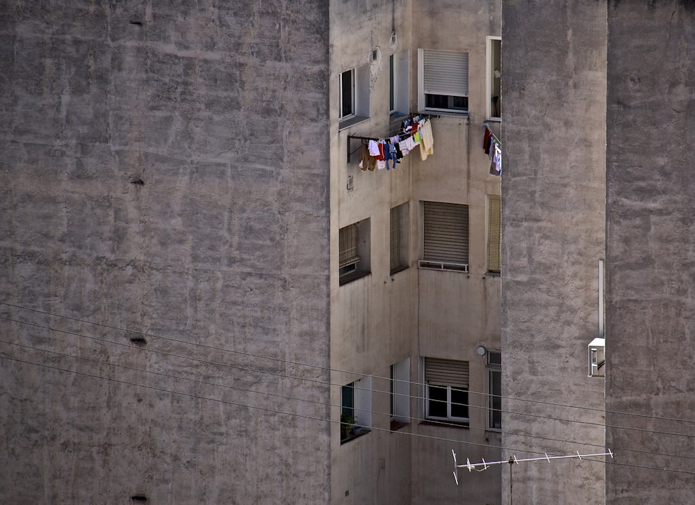 an apartment building with clothes hanging out of the windows