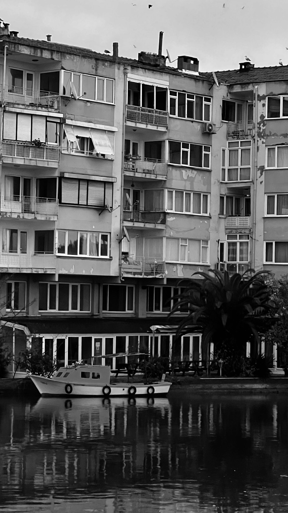 a black and white photo of a boat in a body of water