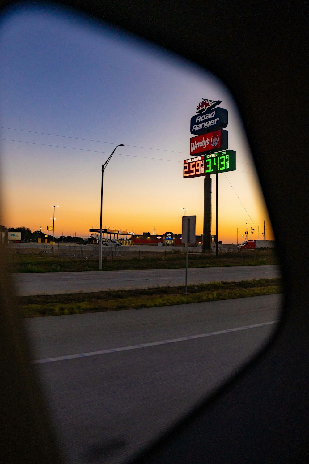 a view of a gas station from a car window