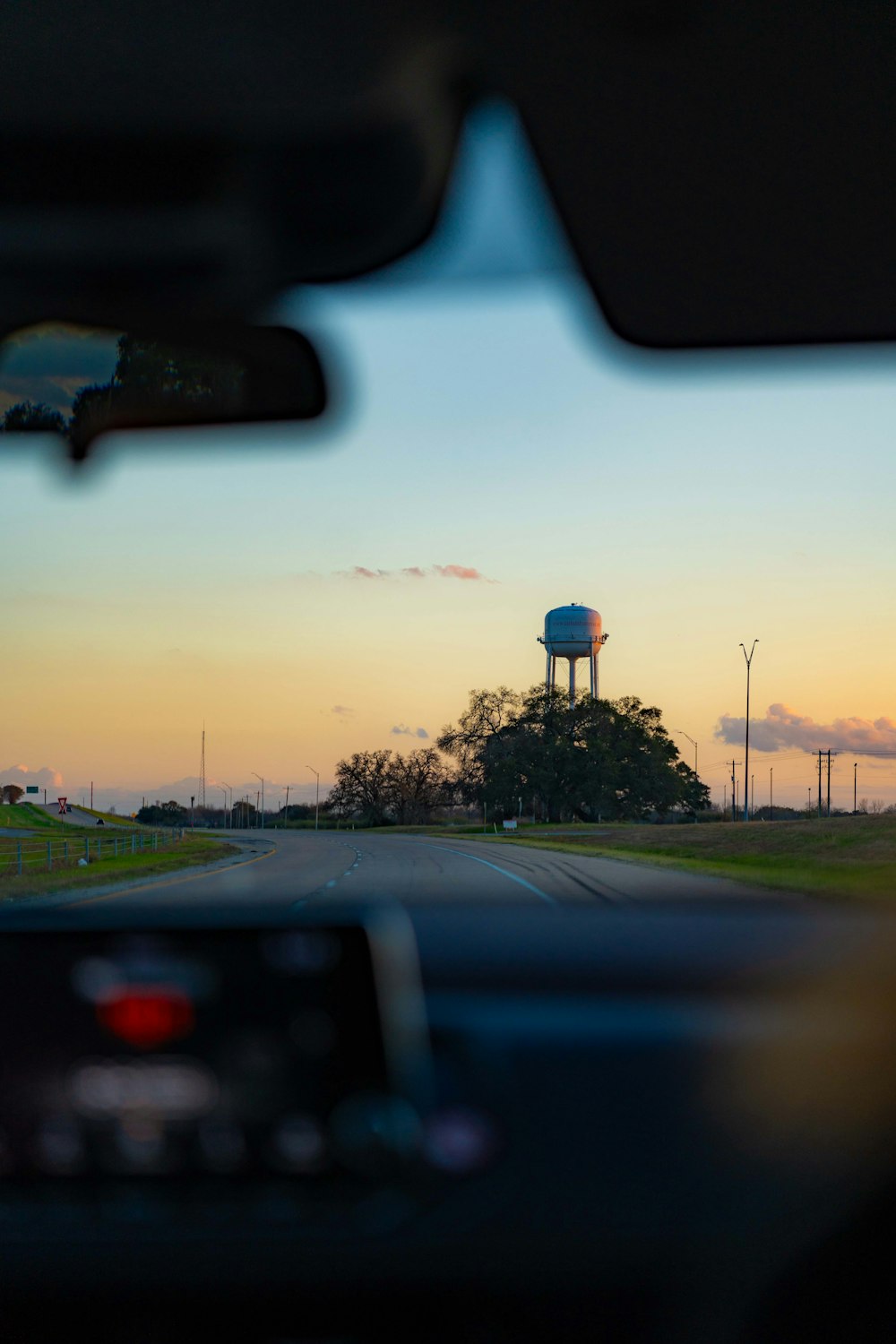 a view of a water tower from inside a car