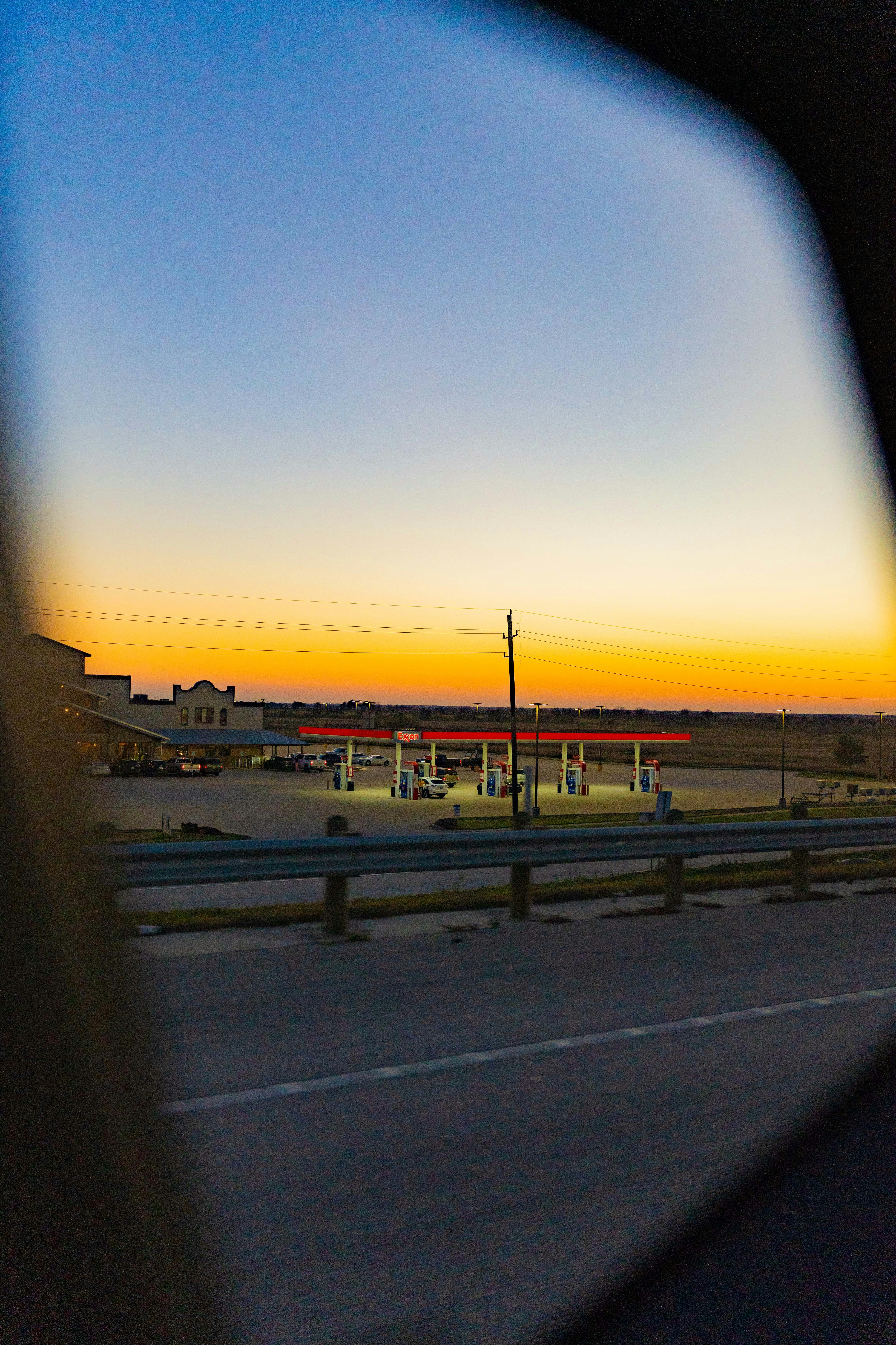 a view of a gas station from a car window