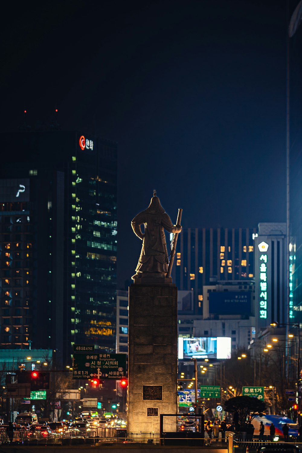 a statue in the middle of a city at night