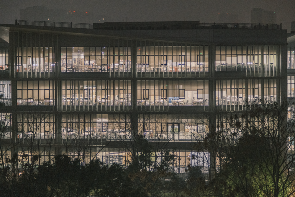 a large building with lots of windows lit up at night