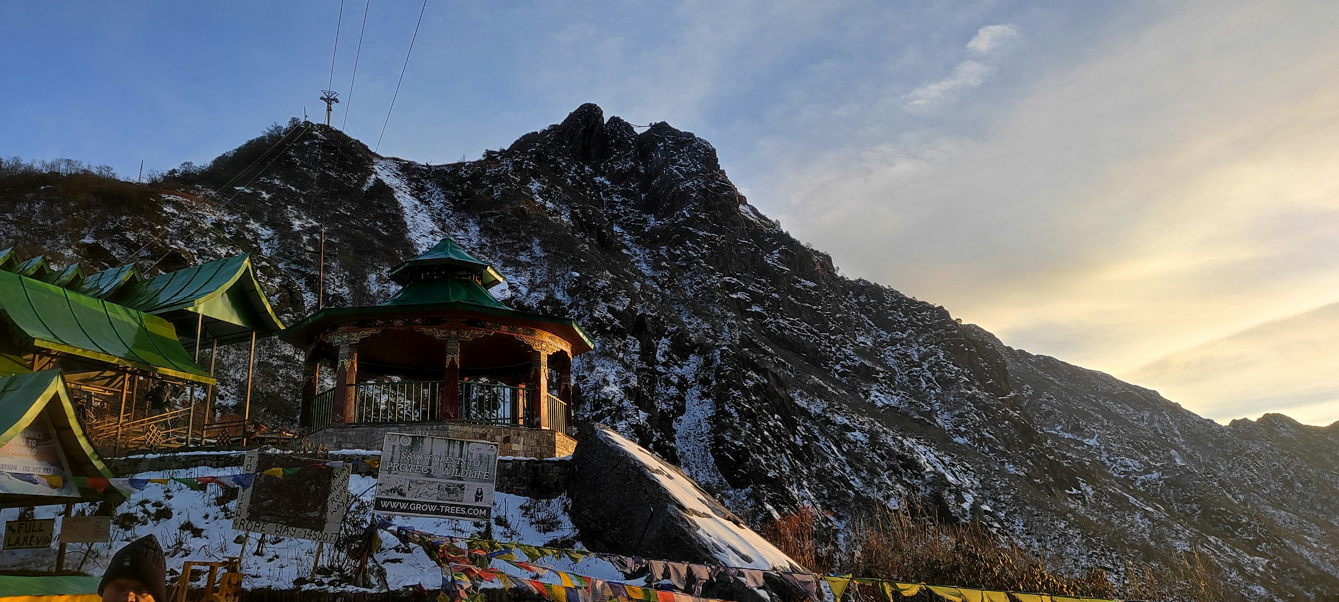 Peaceful meditation space with mountain view, prayer flags, and traditional cushions for spiritual practice