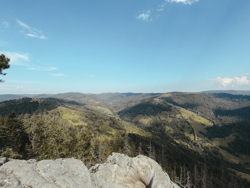 a view of a mountain range from the top of a hill