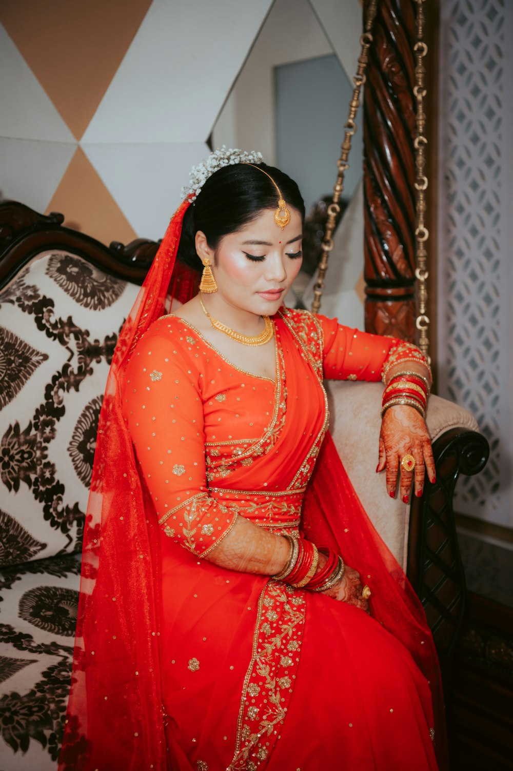 a woman in a red dress sitting on a couch