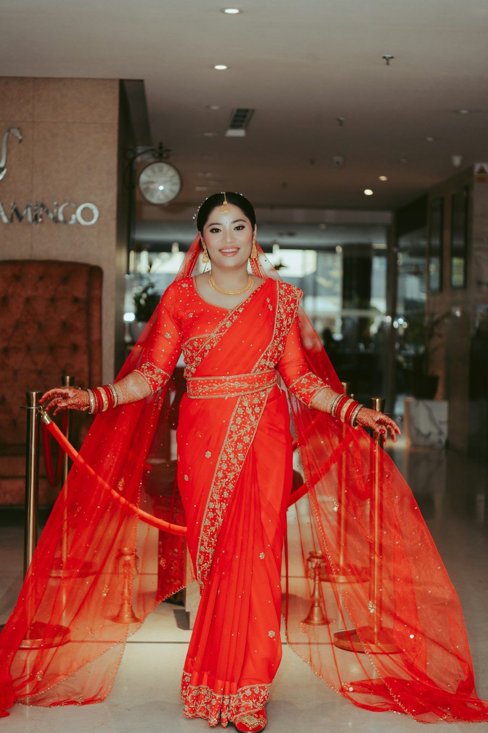 a woman in a red sari posing for a picture