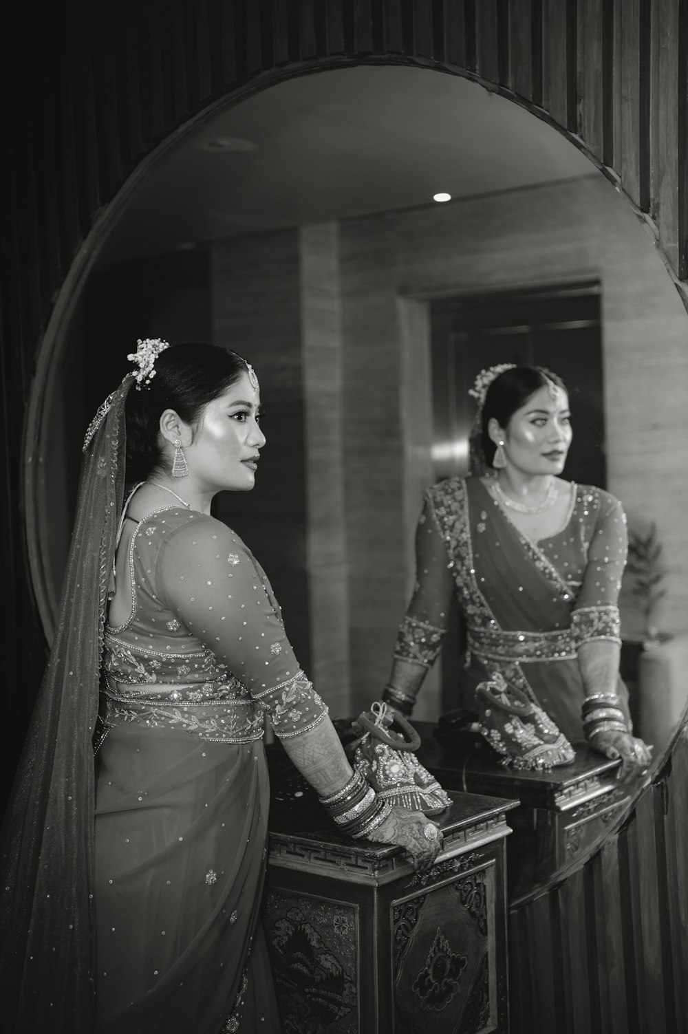 a woman standing in front of a mirror