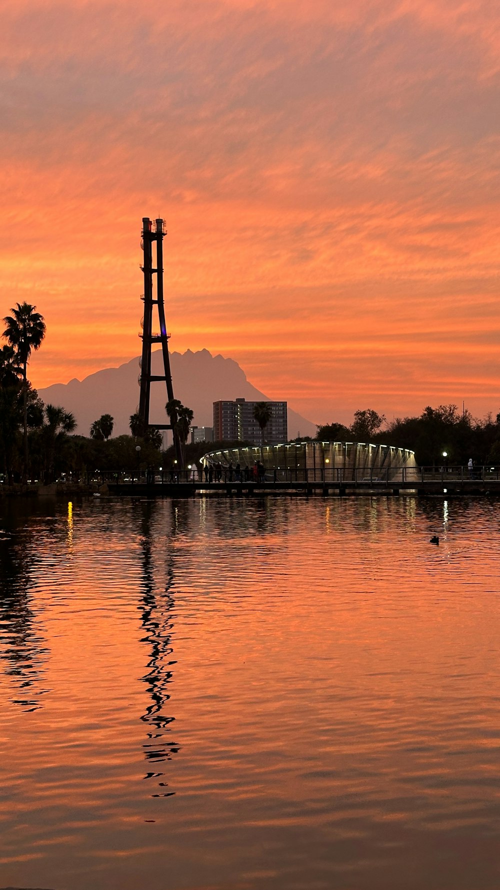 a large body of water with a tower in the background