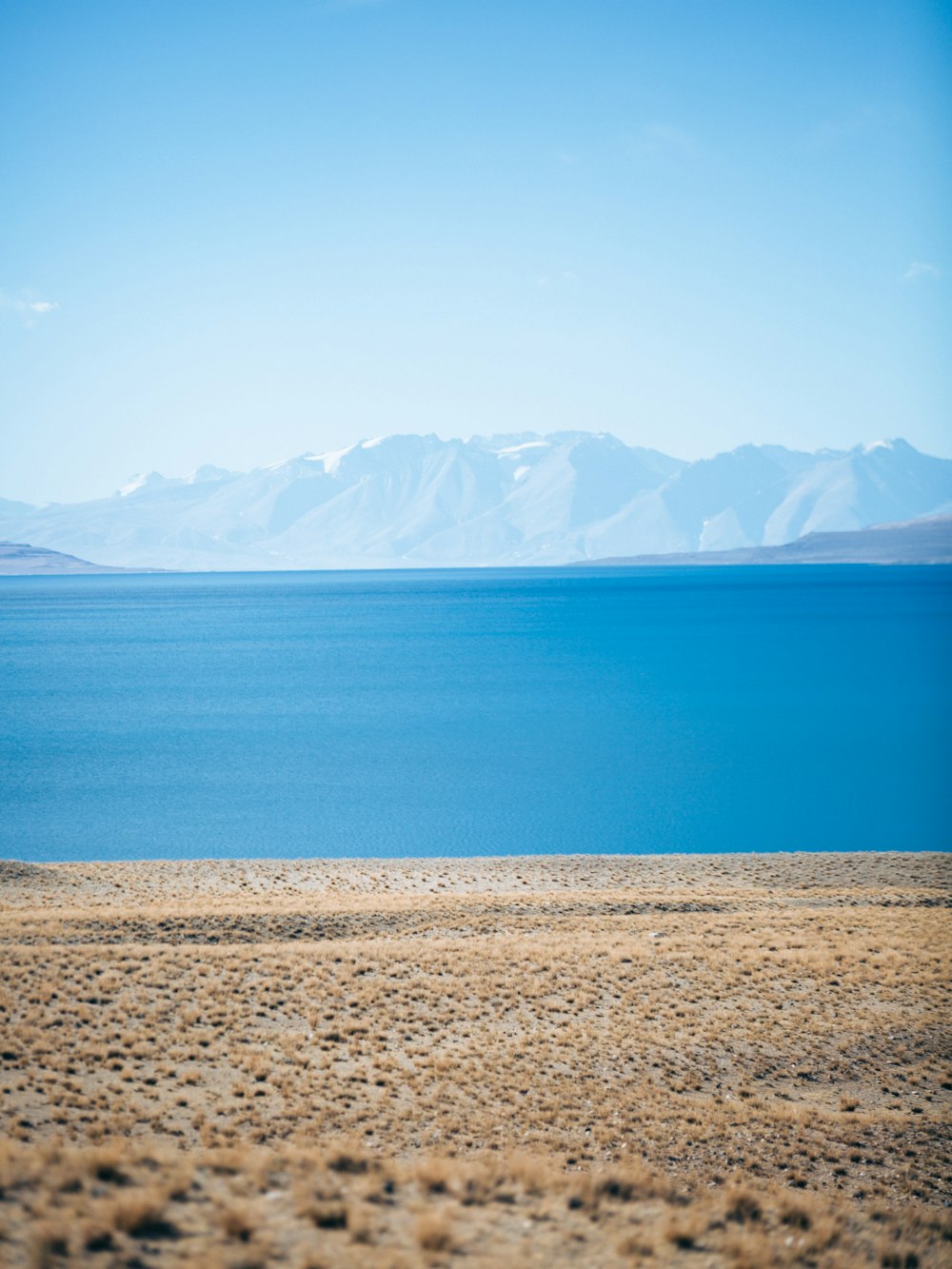 a large body of water with mountains in the background