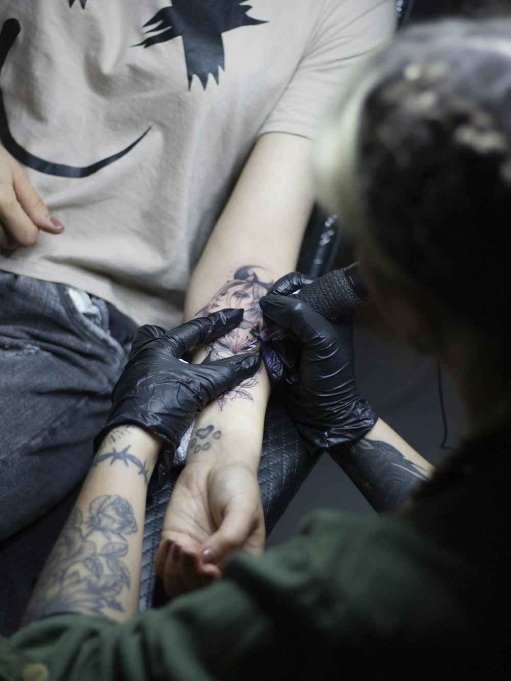 a man getting a tattoo on his arm