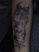 a black and white tattoo of a woman's face