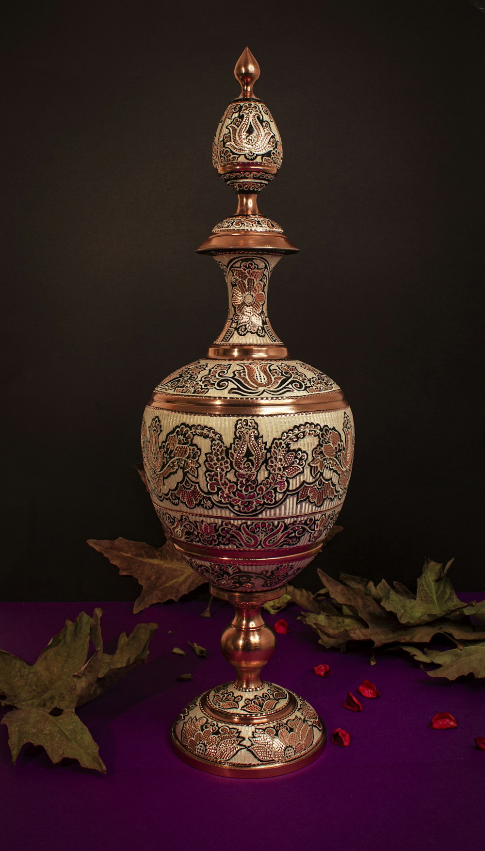 a vase sitting on top of a purple table