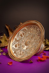 a gold plate sitting on top of a purple table