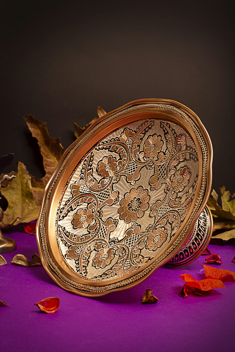 a gold plate sitting on top of a purple table