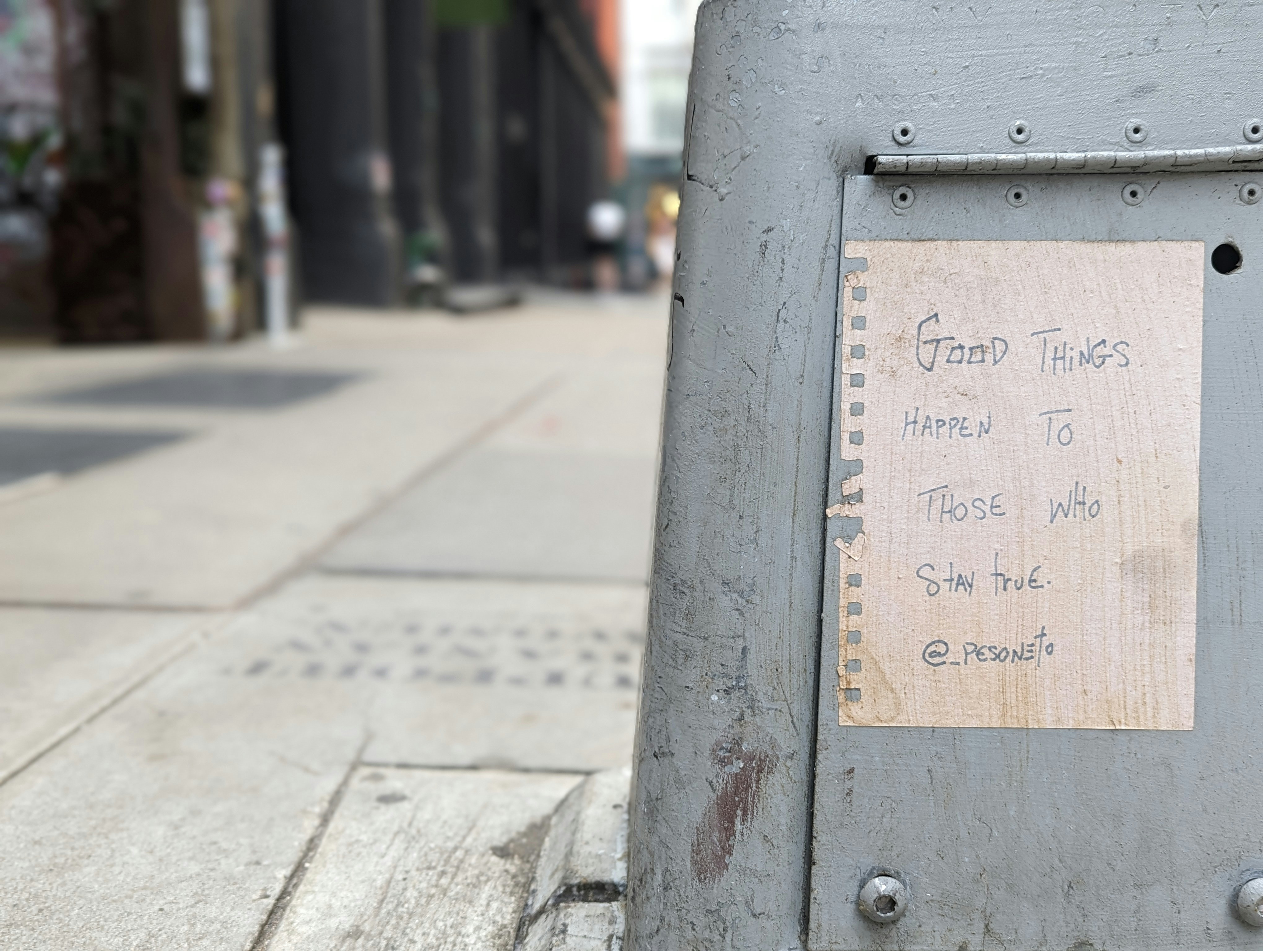 a close up of a street sign on a sidewalk