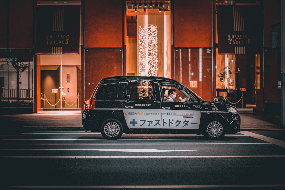 a taxi cab is parked in front of a building