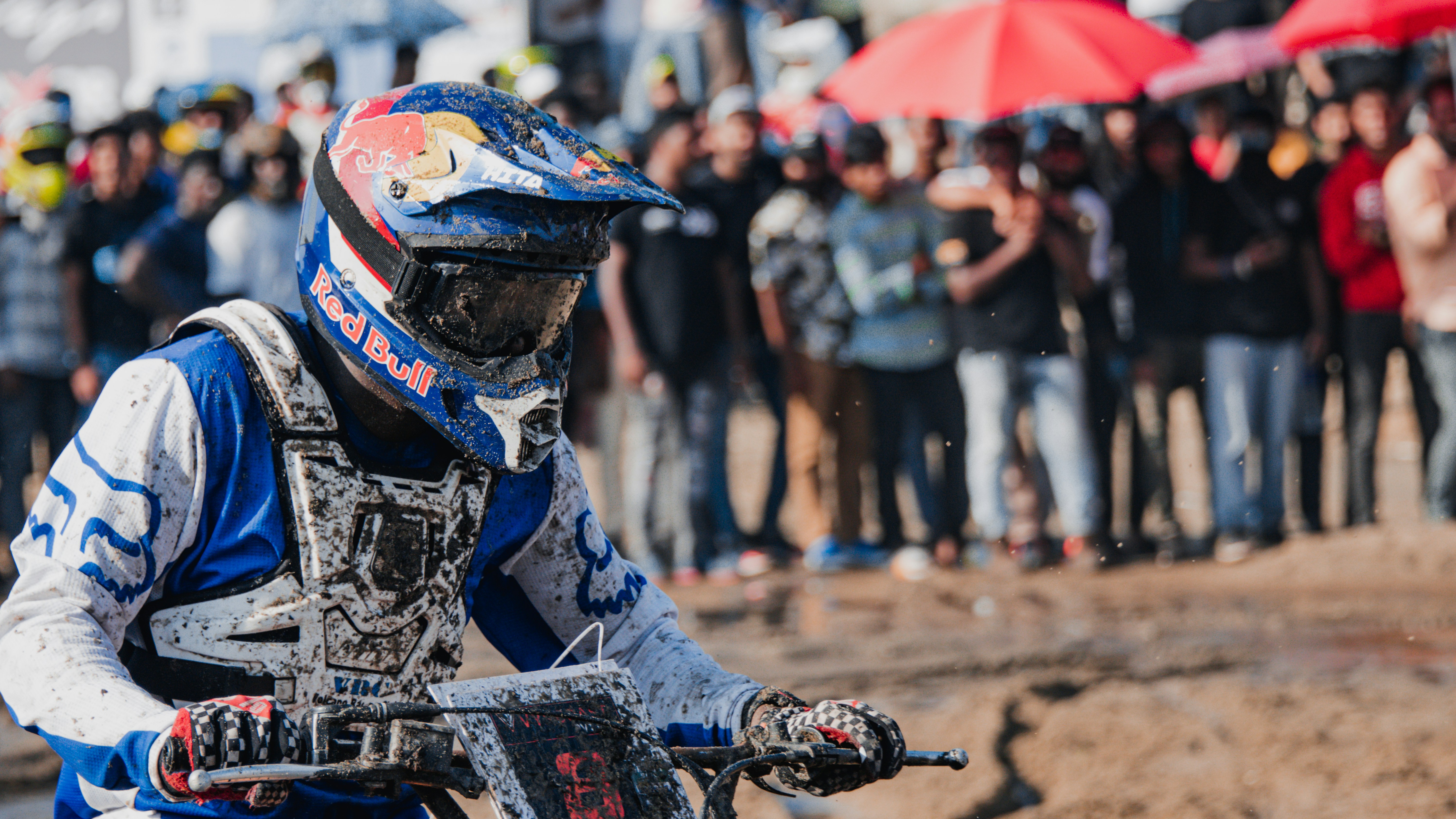 a man riding a dirt bike on top of a dirt field