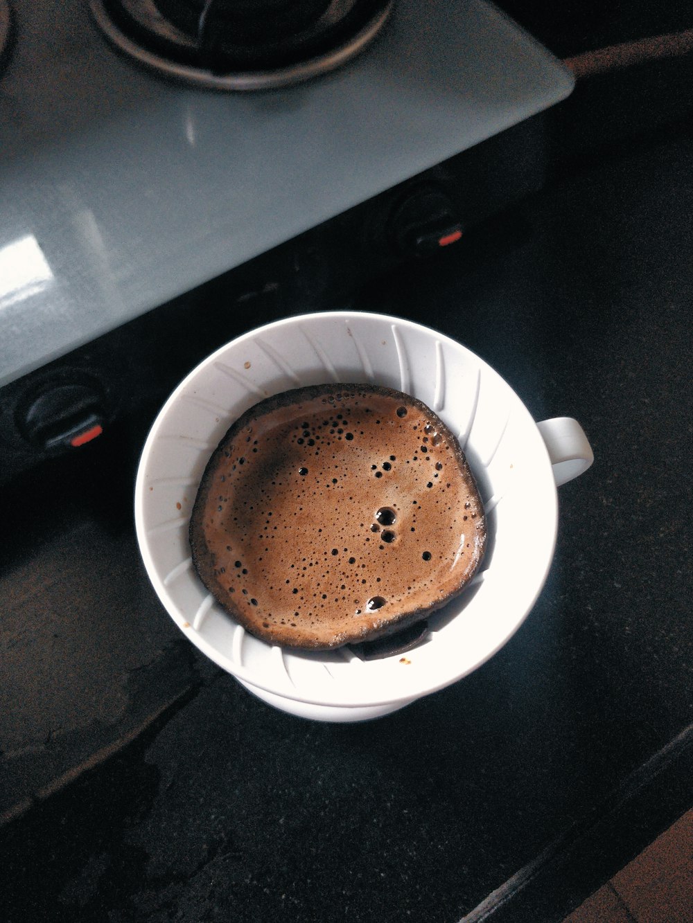a cup of coffee sitting on top of a counter