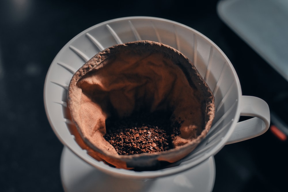 a cup filled with a mixture of coffee