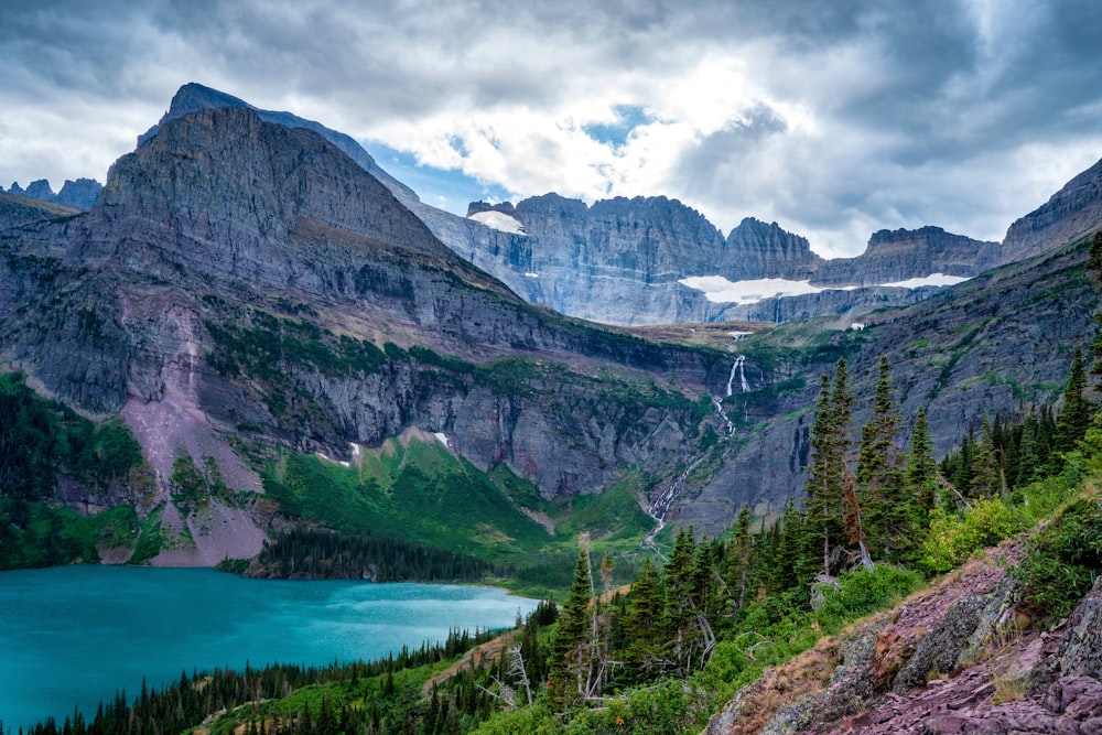 a scenic view of a mountain lake surrounded by trees