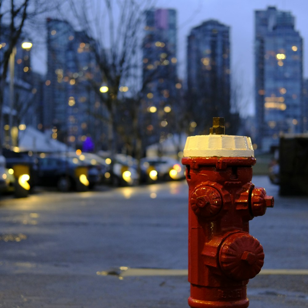 a red fire hydrant sitting on the side of a road