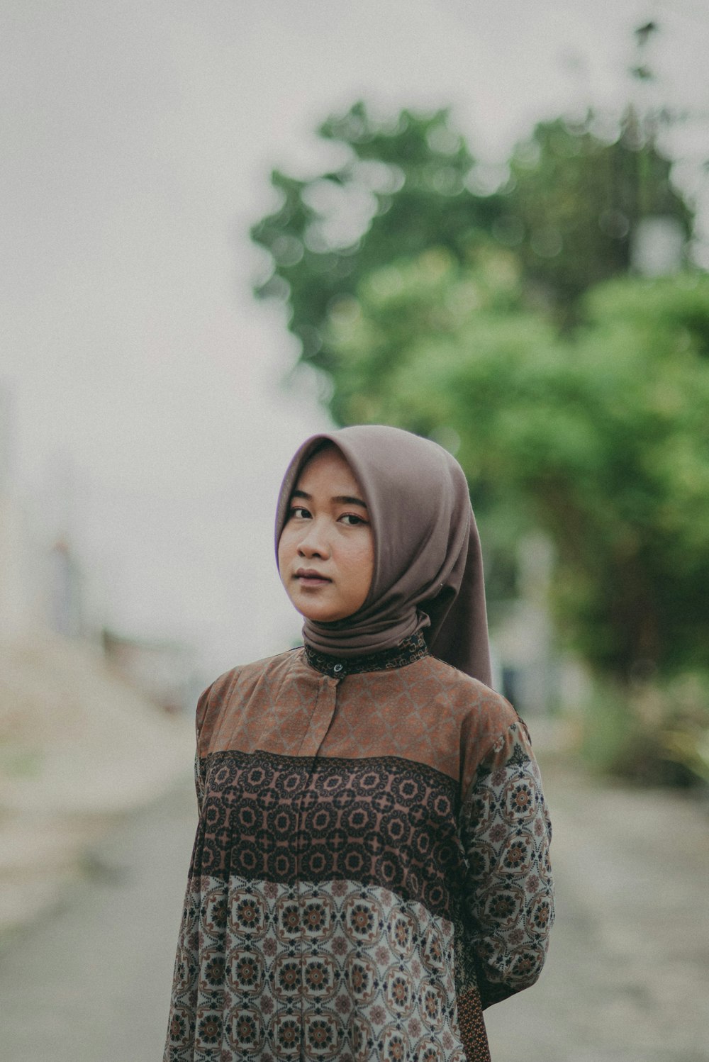 a woman in a hijab walking down a street