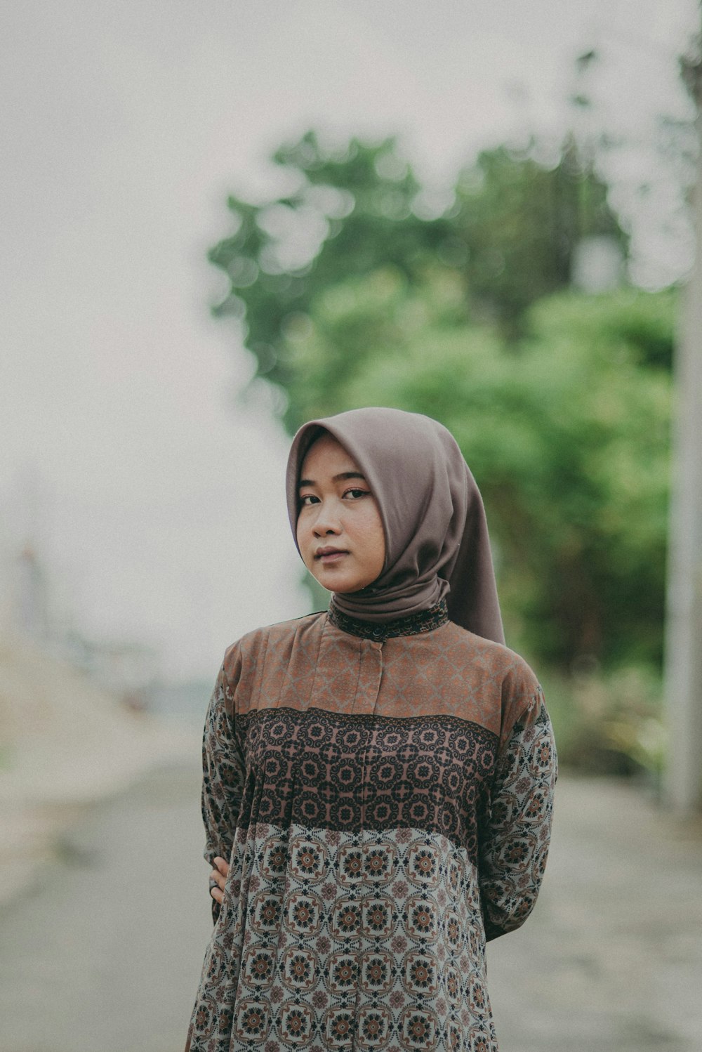 a woman standing on the side of a road