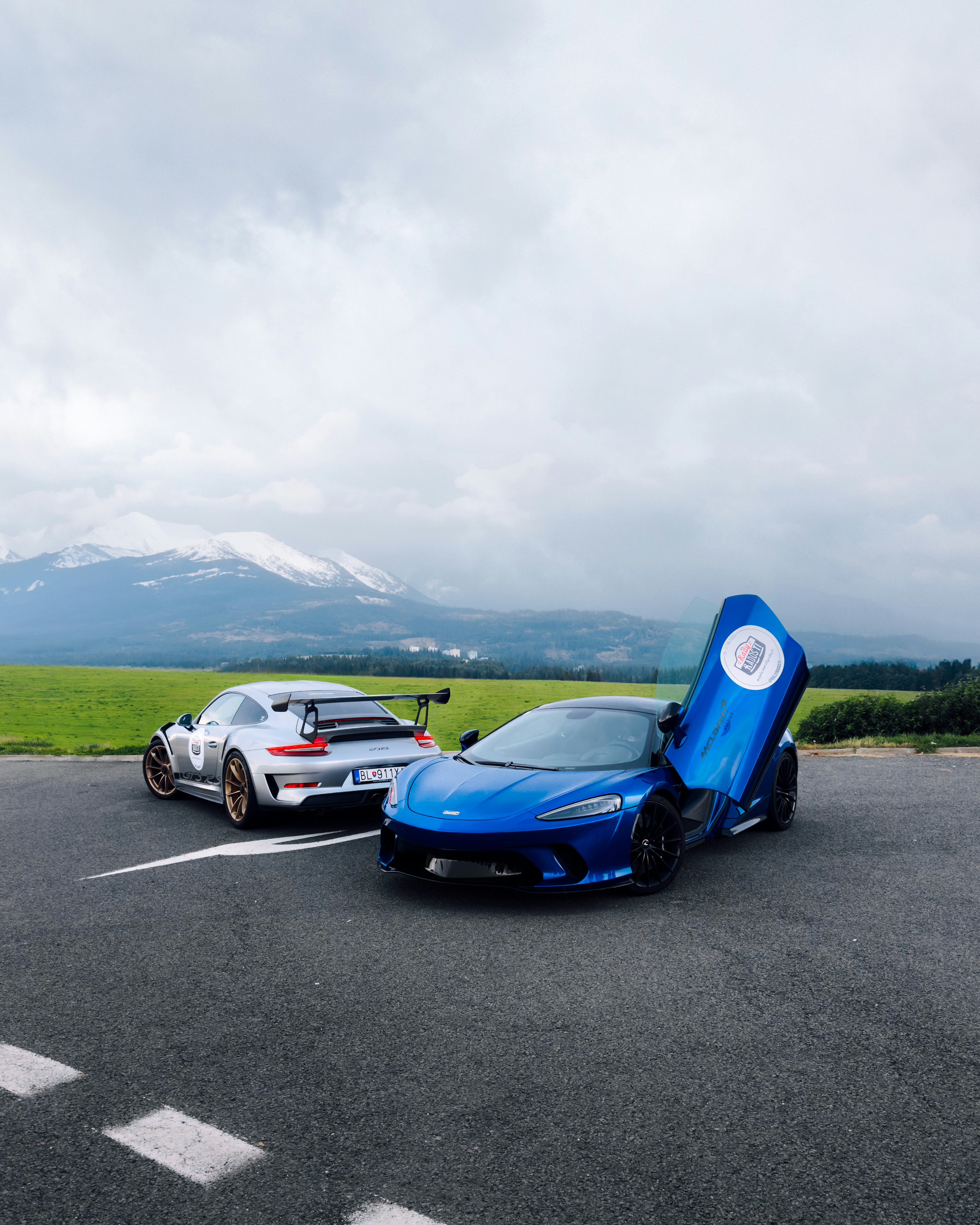 Two cars parked in a parking lot next to each other photo – Free ...