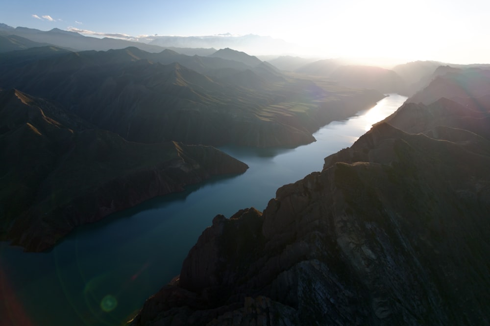 an aerial view of a lake surrounded by mountains