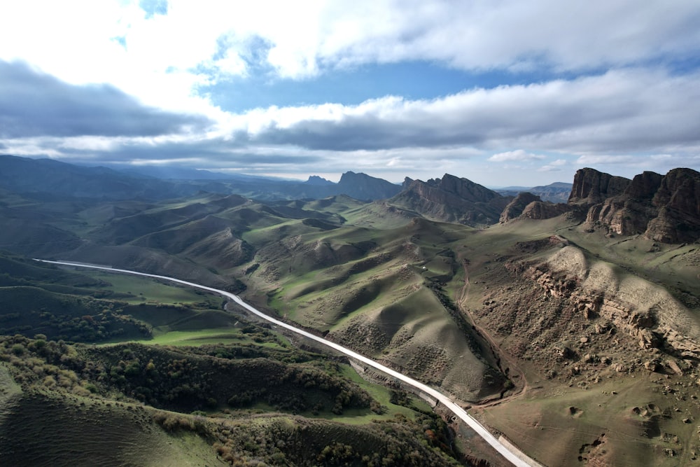 an aerial view of a winding road in the mountains