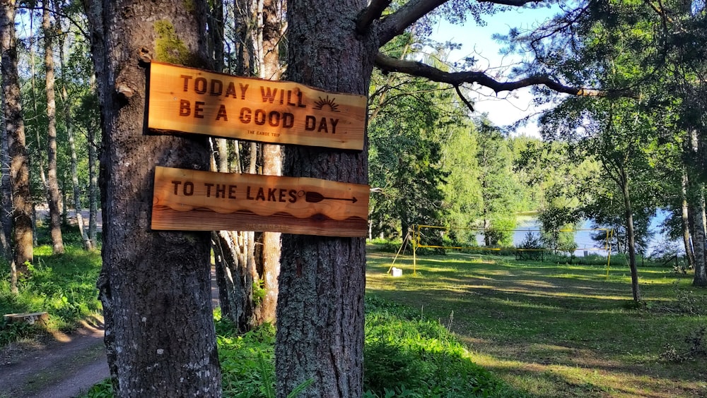 a sign on a tree that says today will be a good day to the lakes