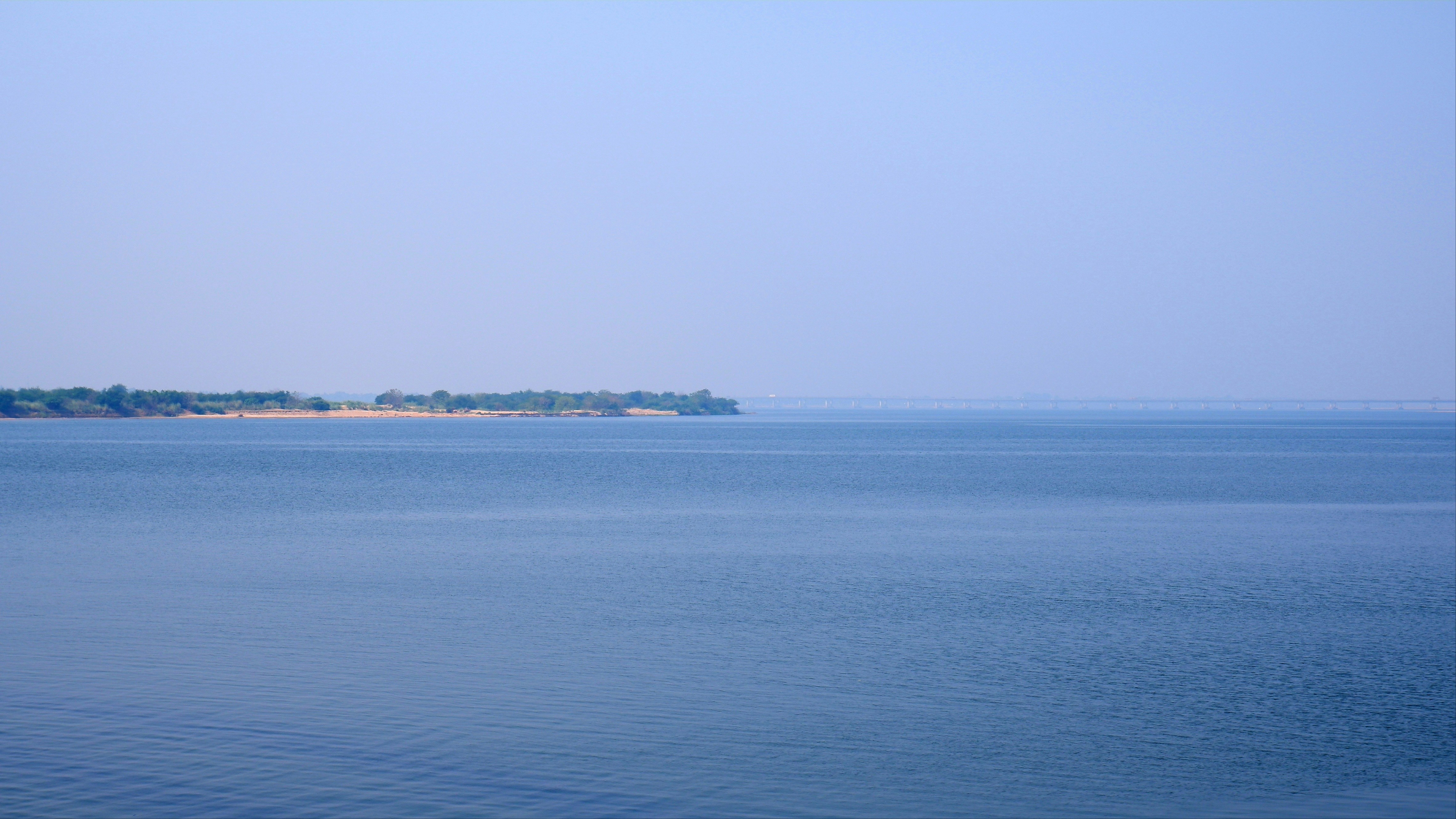 a large body of water with a small island in the distance
