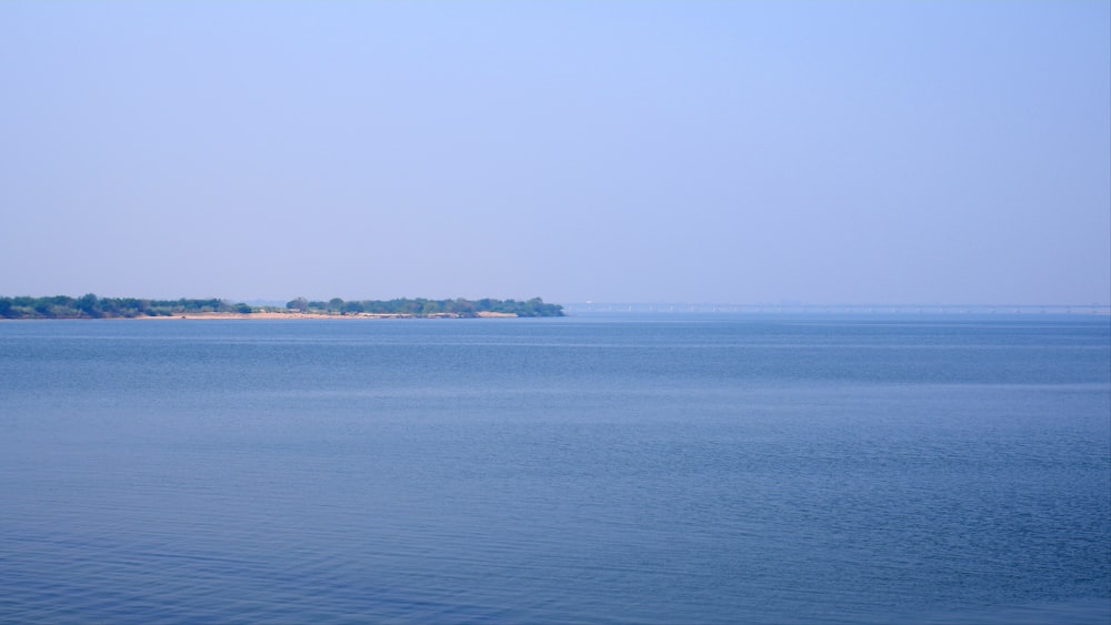 a large body of water with a small island in the distance