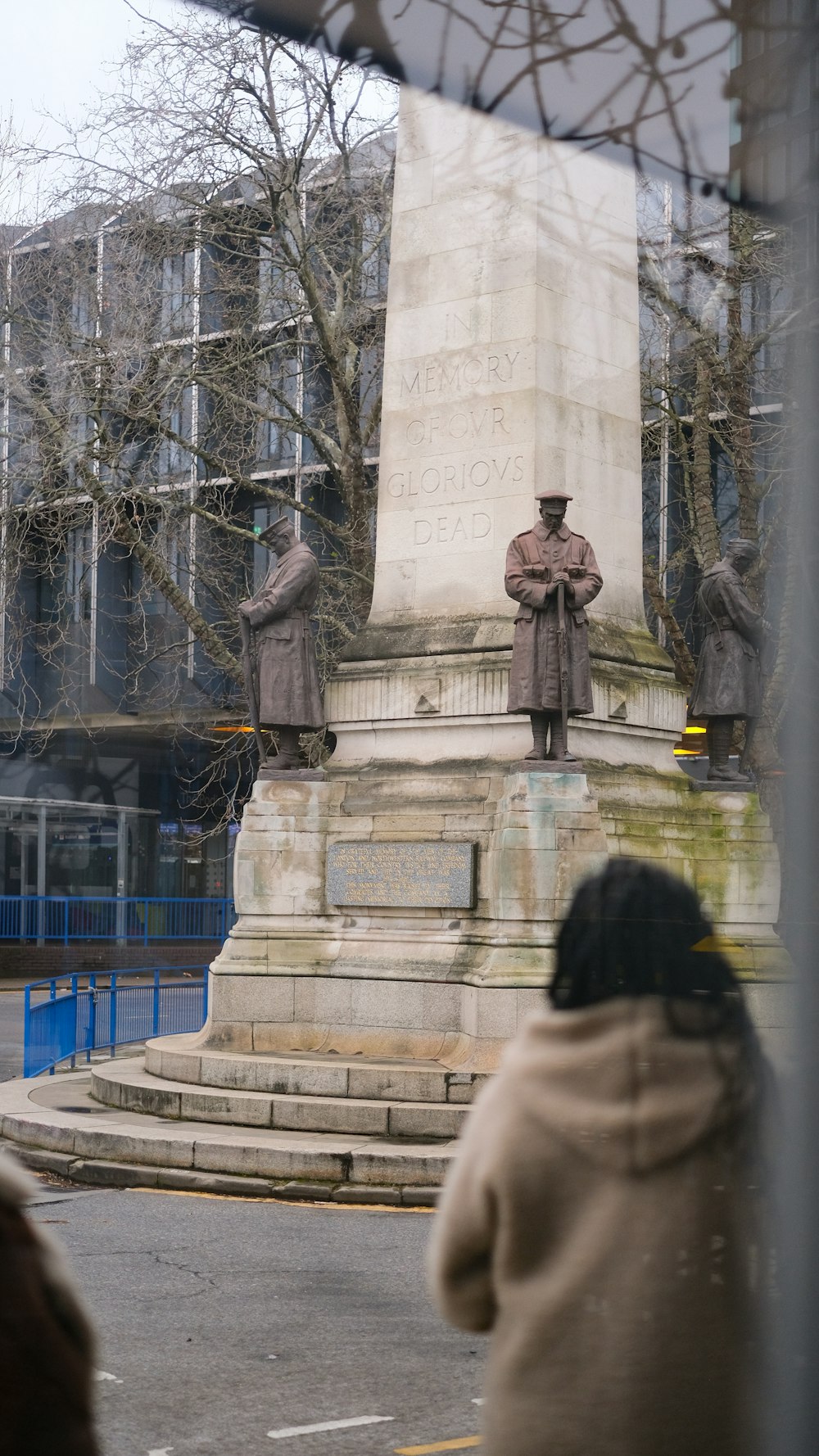 a statue of a man standing in front of a building