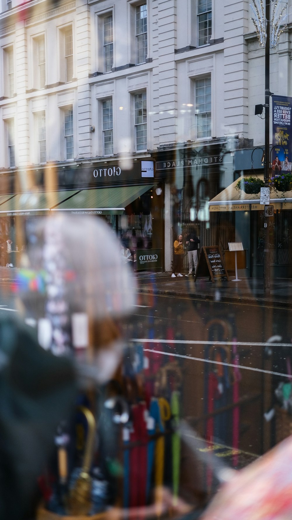 a store front with a lot of umbrellas in the window