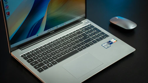 A Windows laptop computer sitting on top of a desk.
