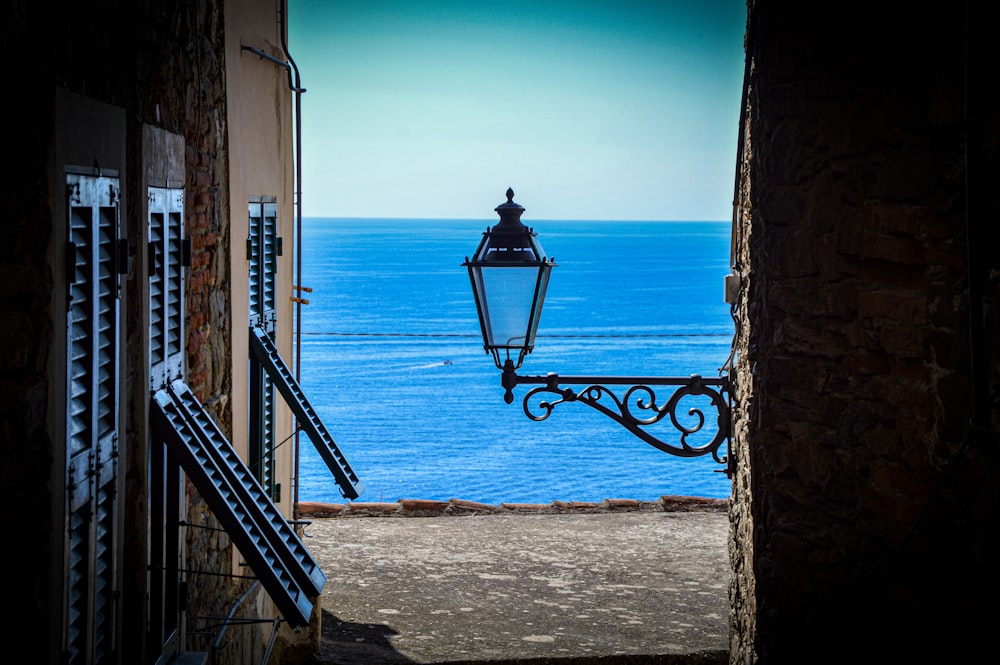 an open door leading to a balcony with a view of the ocean