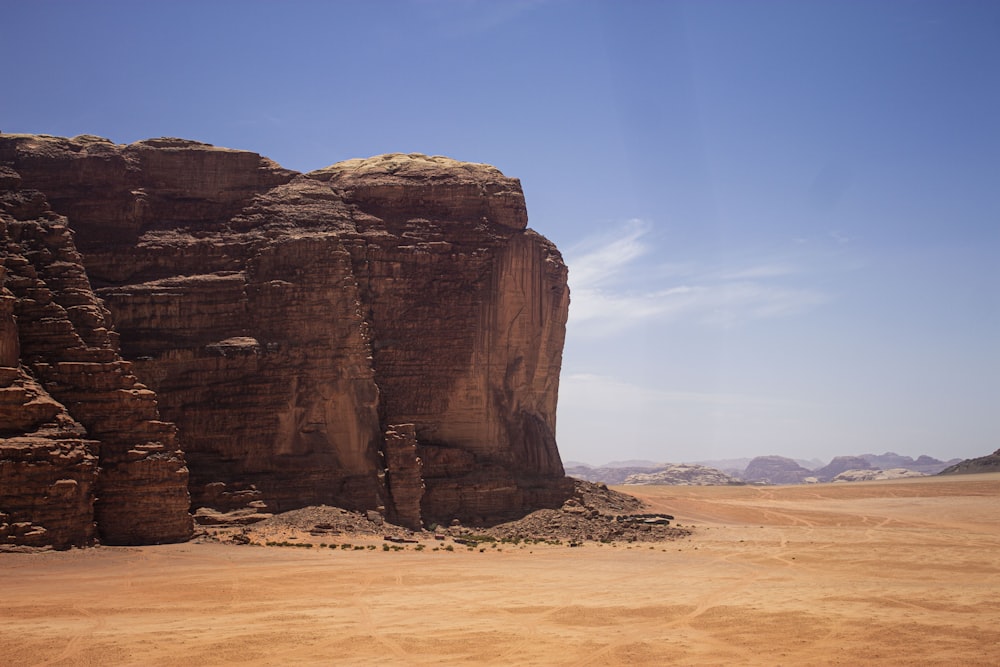 a large rock formation in the middle of a desert