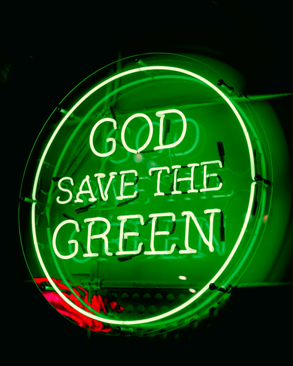 a green neon sign that says god save the green