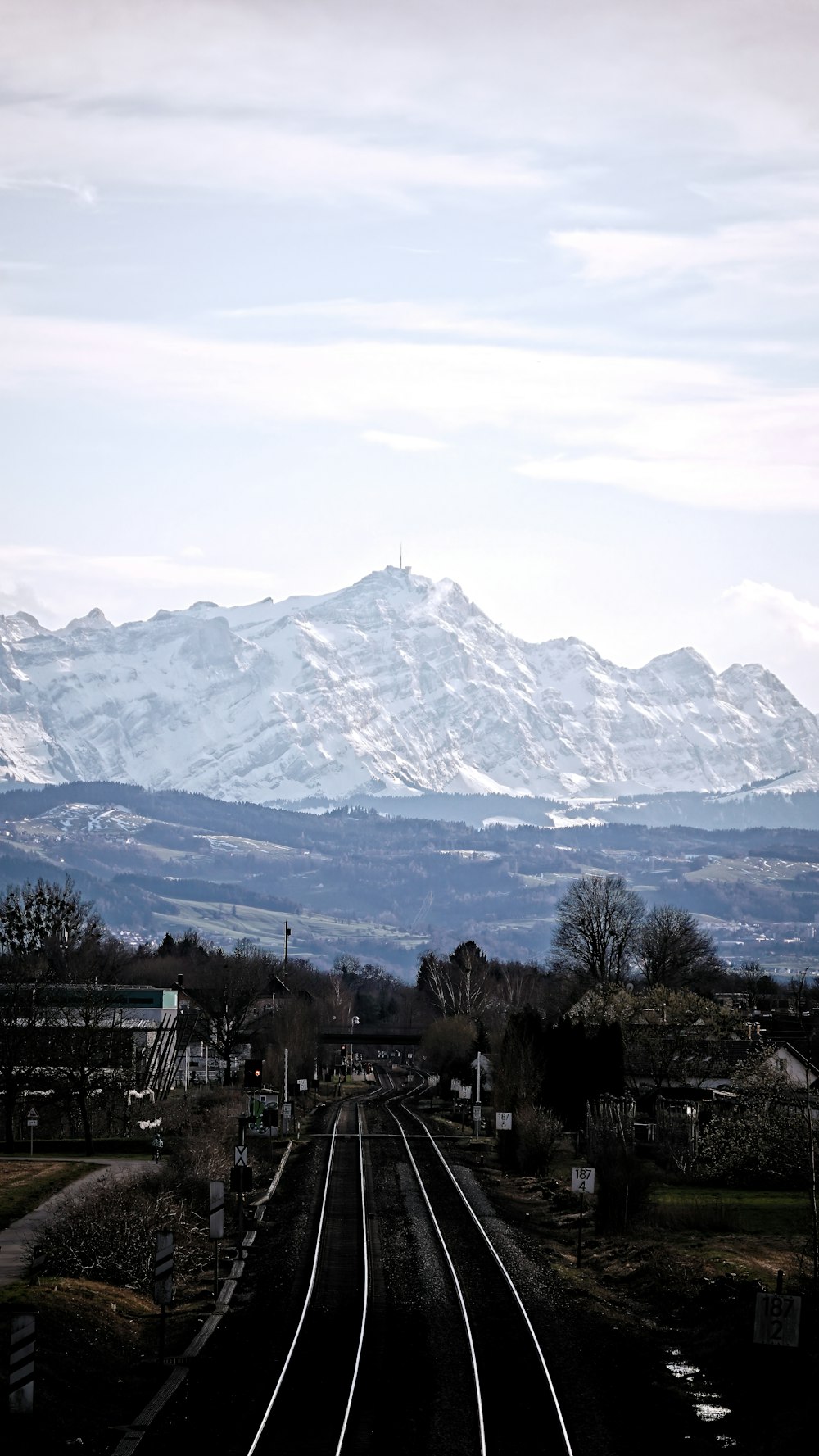 a train track with a mountain in the background