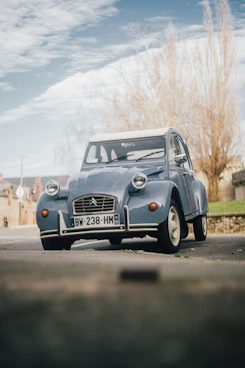 a blue car parked on the side of the road