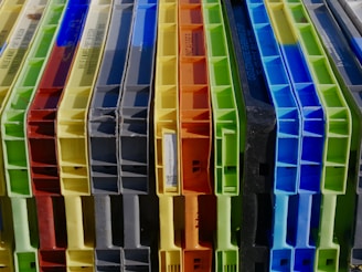 a bunch of different colored plastic containers stacked on top of each other