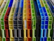 a bunch of different colored plastic containers stacked on top of each other