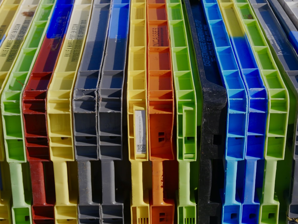a bunch of different colored plastic containers stacked on top of each other