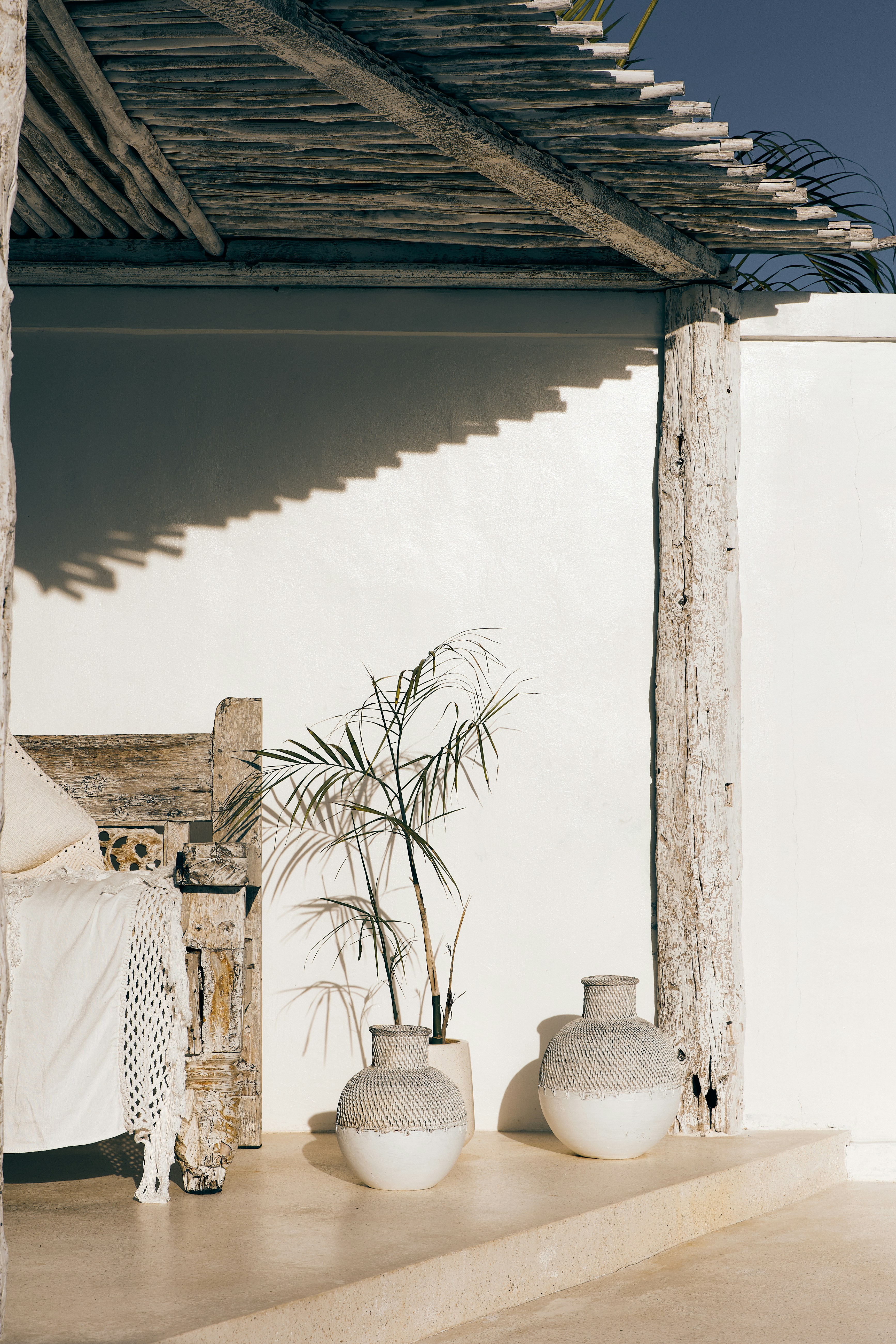 a couple of white vases sitting on top of a table